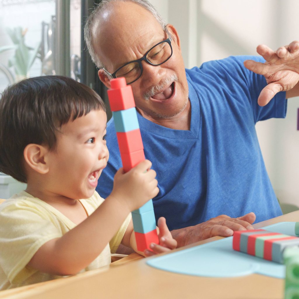 a child playing with his grandfather